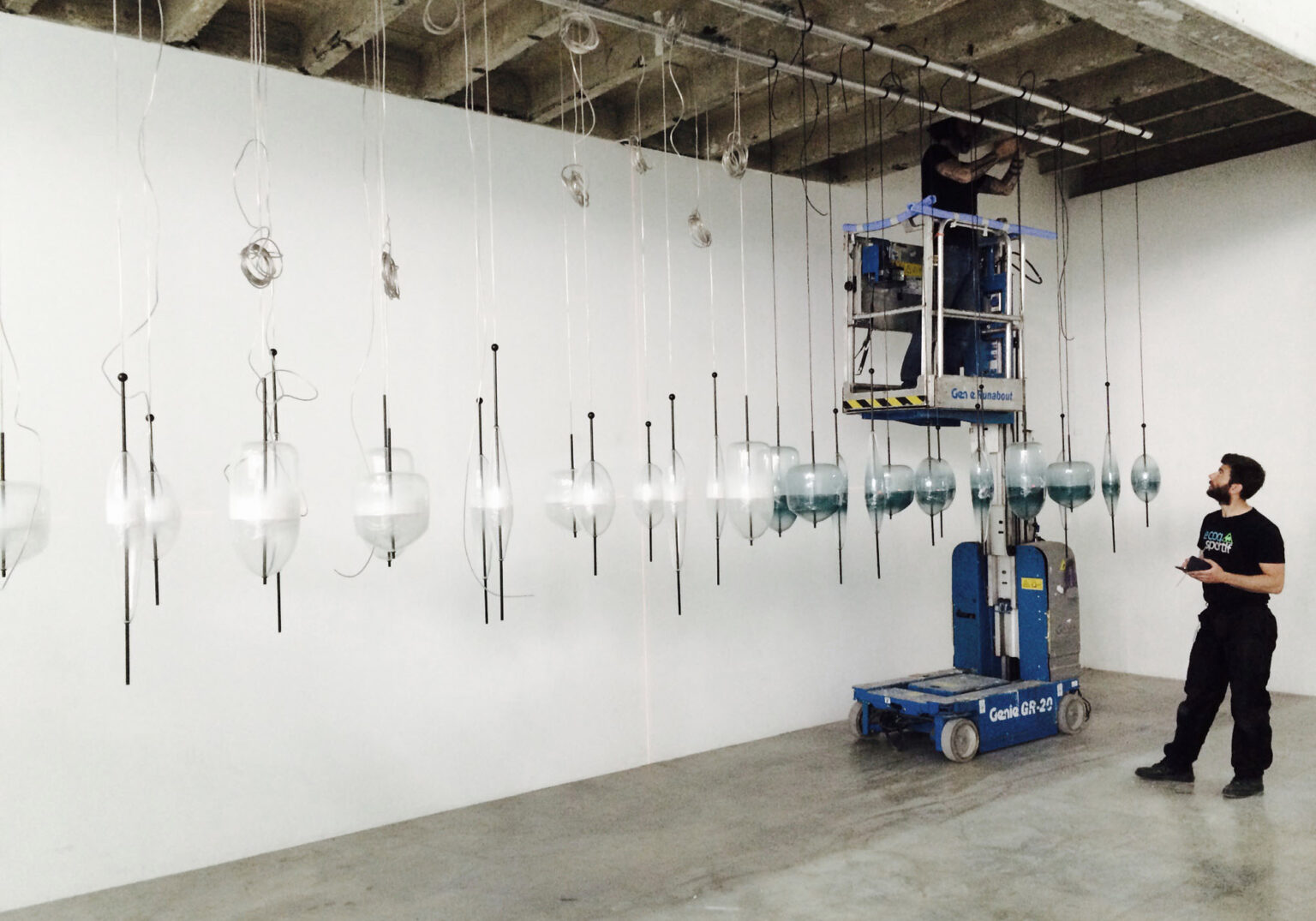 MOVING HORIZON, WonderGlass. Installation by Nao Tamura. | Installation at Palais de Tokyo—thirty lights hung, levelled, and spaced by hand.