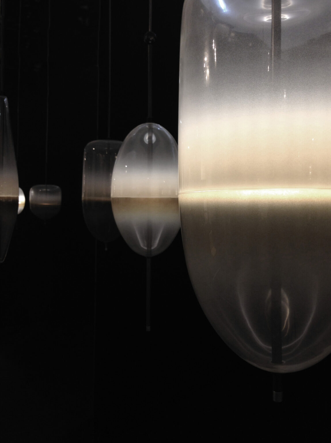 MOVING HORIZON, WonderGlass. Installation by Nao Tamura. | Night FLOW[T], up close. The water line lit, the rest left dark.