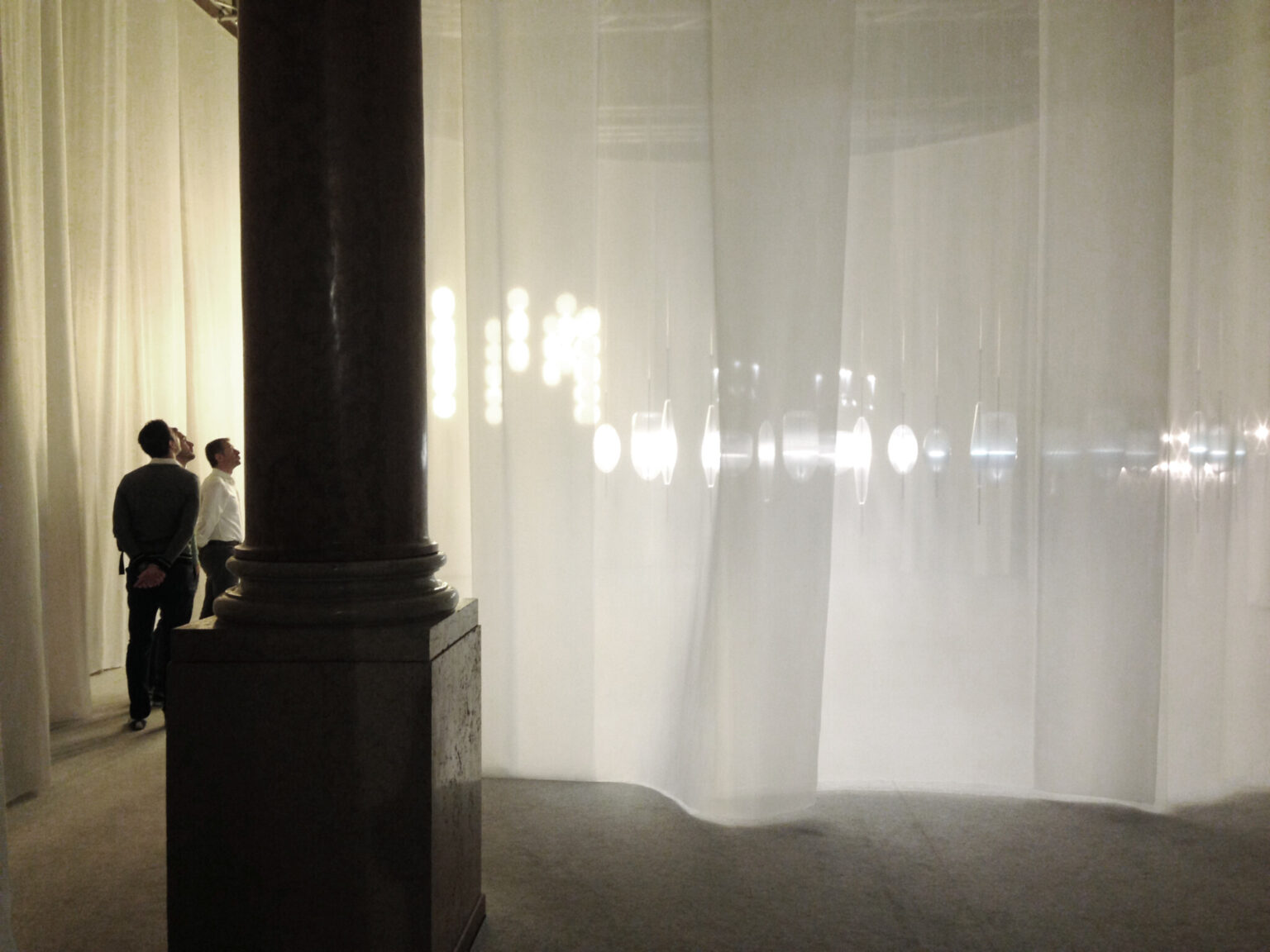 MOVING HORIZON, WonderGlass. Installation by Nao Tamura. | Seen from outside. The column is the building's; the glass is behind the fabric.