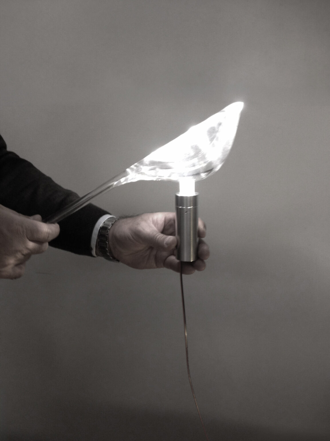 TIKI, Established & Sons. Design by Nao Tamura. | The moment it lit. Light through solid acrylic, held in the maker's hands. The LED still on a bare wire.